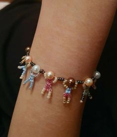 a person wearing a bracelet with charms on it