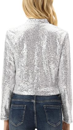 Bring a touch of luxury to your wardrobe with our Shiny Silver Sequin Shrug Blazer Jacket. The long sleeve design and open front style provide a sophisticated look, while the silver sequin detailing adds a touch of glamour. Elevate any outfit with this exclusive piece, perfect for any occasion. Shell/Lining:98%Polyester+2%Viscose Stoff/Futter:98%Polyester+2%Viskose Hand Wash Only Material:98%Polyester+2%Viscose.Sequin jacket with high quality and smooth lined. Comfortable and fashionable. Washing instructions: hand wash/do not bleach/hang to dry. Glamorous Long Sleeve Holiday Outerwear, Fitted Silver Sequined Outerwear, Metallic Long Sleeve Top With Sequins, Glamorous Metallic Long Sleeve Outerwear, Glamorous Long Sleeve Outerwear With Sequins, Glamorous Long Sleeve Sequined Outerwear, Silver Sequined Evening Outerwear, Silver Sequined Outerwear For Evening, Metallic Long Sleeve Outerwear For Party Season