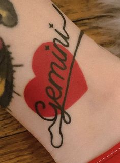 a woman's arm with tattoos on it and the word love written in cursive writing