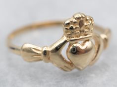 Claddagh rings are a traditional token of affection, with the crown, heart, and hands representing loyalty, love, and friendship. This piece would make a special promise ring or wedding band!Metal: 14K Yellow GoldWidth of Band: 9.7 mmHeight off Finger: 2.2 mmRing Size: 6 Claddagh Ring Wedding, Gold Claddagh Ring, Claddagh Ring, Band Metal, Love And Friendship, Claddagh Rings, Irish Jewelry, Irish Wedding, Unique Engagement