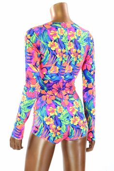 "This item is made to order, please read all the way through the listing before purchasing! This bodysuit is made of a beautiful UV glow Tahitian Floral print lycra spandex Long sleeves and boy cut legs. This fabric has an amazing bright neon glow under UV blacklight. Four way stretch for a figure forming fit. This bodysuit is unlined. Womens Sizing (See below for instructions on where measurements should be taken) XXS: Bust 29\"-30\" / Waist 22\"-23\" / Hips 30\"-32\" Extra Small: Bust 31\"-32\ Tropical Long Sleeve Fitted Swimwear, Fitted Long Sleeve Tropical Swimwear, Fitted Multicolor Printed Bodysuit, Summer Long Sleeve Fitted Unitard, Green Bodysuit For Surfing, Fitted Printed Beachwear Bodysuit, Fitted Printed Bodysuit For Swimming, Fitted Printed Bodysuit Beachwear, Green Stretch Bodysuit For Surfing