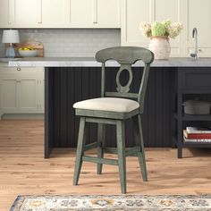 a kitchen with an island and stools in it