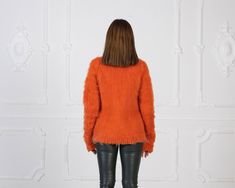 "MATERIAL : 2 strands Extra Fine Merino wool COLOUR : Orange ( There may be a slight difference because of the different monitors' representation) ♥ In the picture the model is wearing a garment with these measurements : A: ( Body lenght) : 26 \" / 66 cm B: ( Chest width) : 17.3 \" / 44 cm C: (Sleeve from under the arm) : 22.4 \" / 57 cm D: (Neck unrolled) : 12.6 / 32 cm. They are taken with the item laid flat and not streched. ♥ For choosing your size please look at size chart in our listing pi Fine Knit Mohair Tops For Fall, Fine Knit Mohair Sweater For Fall, Mohair Long Sleeve Sweater For Fall, Long Sleeve Mohair Top For Fall, Winter Fine Knit Mohair Tops, Fall Knitted Mohair Tops, Fitted Mohair Sweater For Layering, Fitted Mohair Sweater For Fall, Fall Mohair Crew Neck Top