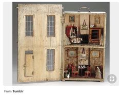 an open doll house with furniture inside