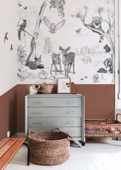 a baby's room decorated in pink and white with an animal mural on the wall