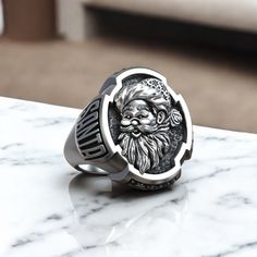 Celebrate the magic of the holiday season with this Santa Claus Christmas Saint Nicholas Believe Ring, exquisitely crafted from 925 sterling silver. This unique ring features a detailed design of Santa Claus, symbolizing joy, generosity, and the spirit of Christmas. Perfect for both men and women, this festive statement piece adds a touch of holiday cheer to any outfit. The adjustable band ensures a comfortable fit, making it an ideal addition to your seasonal jewelry collection. Whether you're Viking Ring, Masonic Ring, Retro Ring, The Spirit Of Christmas, Animal Rings, Saint Nicholas, Spirit Of Christmas, Santa Claus Christmas, Everyday Rings