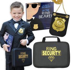 a little boy in a suit and tie is holding some kind of bag with the words ring security on it