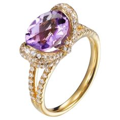 Bursting with vibrant violet hues, this beautiful ring is sure to attract admiring glances. Featuring an oval cut Amethyst, weighing 1.37 carat, surrounded by 2.28 carat of round brilliant cut cubic zirconia, sitting beautifully in a split shank, composed of 925 sterling silver with either a 14 karat yellow gold or a high gloss white rhodium finish. Whether you're looking for a classic piece to add to your jewelry box, or something totally on-trend, designers Lustre of London believe that every Rings Opal, Amethyst Ring Engagement, Cushion Cut Engagement, Gold Statement Ring, Engagement Rings Opal, Amethyst Gold, Diamond Simulant, High Gloss White, Vintage Cocktail