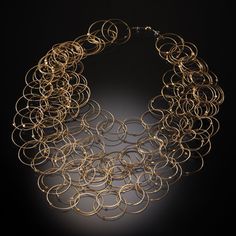 Gold & Steel Necklace - Hand-formed rings of 14k gold-plated stainless steel cable create a tumbling cascade of interconnected links on this lightweight necklace. The overlapping circles create a unique pattern reminiscent of Venn diagrams. Neodymium magnet clasp. Modern Multi-strand Gold Jewelry, Modern Gold Multi-strand Jewelry, Venn Diagrams, Overlapping Circles, Creative Necklace, Stainless Steel Cable, Bronze Gold, Neodymium Magnets, Steel Necklace