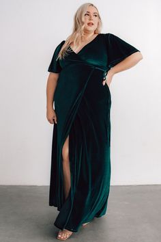 Feel luxurious in an instant Emerald mid-weight velvet material, perfect for all seasons Slight stretch throughout fabric True wrap style with V-neckline and waist tie Mid-length sleeves with a subtle bell shape Long skirt with tulip hem If your bust and waist measurements are the same, we recommend sizing up for more coverage at bust Bump and nursing friendly 100% Polyester Hand wash cold, lay flat to dry. Steam from inside in case of wrinkles. Marianne is 5’6”, cup size 32B, size 4 and wearing Plus Size Easter Dress, Plus Size Velvet Dress, Green Spring Dresses, Plus Size Velvet, Velvet Wrap Dress, Dress Work, Baltic Born, Wrap Maxi Dress, Date Dresses