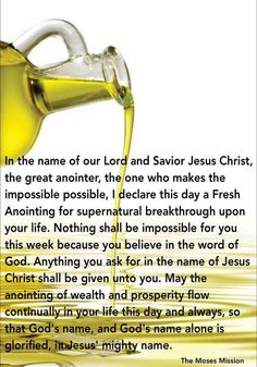 a glass bottle filled with olive oil next to an open bible verse about jesus christ