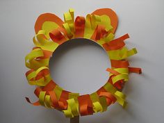 an orange and yellow paper wreath on a stick