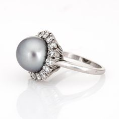 This is part of Chairish’s Fine Jewelry assortment.  Finely detailed vintage Van Cleef & Arpels South Sea Pearl & diamond ring crafted in platinum (circa 1980s to 1990s).   South Sea Pearl measures 11mm. 16 diamonds total an estimated 1.20 carats (estimated at E-F colour and VVS2 clarity). The pearl is lustrous with a light gunmetal grey colour & soft peacock rose overtones.   The mounting is made by Van Cleef & Arpels, signed and numbered with a special designation of "mtg only" for mounting on Classic Platinum Cluster Halo Ring, Classic Platinum Cluster Ring, Classic Platinum Cluster Diamond Ring, Luxury Formal Platinum Pearl Ring, Formal Brilliant Cut Pearl Ring In Platinum, Classic Cluster Diamond Ring In Platinum, Hallmarked Platinum Cluster Ring, White Gold Platinum Halo Ring, Platinum Halo Ring In White Gold