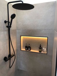 the shower head is mounted on the wall above the shelves in this modern style bathroom