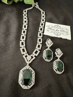 Diamond necklace with doublet emerald green stones. The white rhodium polish with premium quality colored stones with American diamond stones. Comes with matching earrings.the back has silver chain with rings to adjust the length.  Sleek n classy design.  P.S: non returnable product. Please ask any question if you have related to this product before purchasing as returns for size, color etc are not covered. Buyer is responsible for return shipping cost in these cases. Ad Necklace Set, Emerald Green Stone, Cocktail Necklace, Classy Design, Diamond Necklace Set, Green Stones, Cubic Zirconia Jewelry, Colored Stones, American Diamond