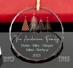 a glass ornament with trees on it and the words, the anderson family