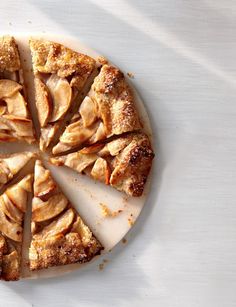 a sliced apple pie sitting on top of a white plate