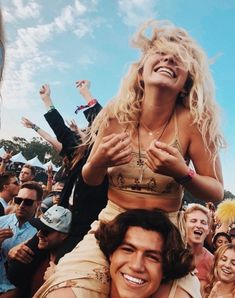 a woman is sitting on the shoulders of a man in front of a group of people