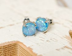 Gorgeous Blue Fire Opal earrings!   These gems reflect so many colors and are simply elegant and stylish! I was thrilled when I received my opals, pinks, whites, blues and purples  Ethical Purchase =) 5mm X 5mm Simulated Opal Sterling silver push back 4 prong  October birthstone Please check out store for more gift ideas :) https://www.etsy.com/ca/shop/PersonalizedByLD Lisa Hypoallergenic Round Cut Earrings For Gift, Fire Opal Earrings, Blue Fire Opal, Opal Stud Earrings, Opal Earrings Stud, Opal Studs, Blue Fire, October Birthstone, Opal Earrings