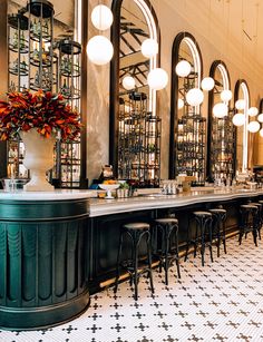 the bar is decorated with black and white checkered flooring, chandeliers hanging from the ceiling