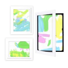 three framed art pieces with different colors and designs on them, one is white the other is green