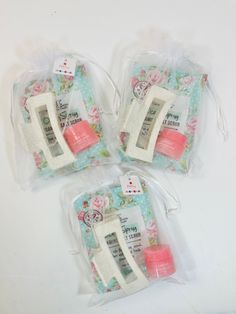 three pieces of sewing fabric in plastic bags on a white surface with pink and blue flowers