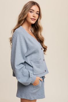 - Color: Light Denim - Cardi + Shorts ribbed knit set - Button down - Long sleeve - Patch pockets - Drawstring waist - Pockets on pants - Elastic waist - Finished with clean hem - Content: 98% cotton 2% spandex - Model is 5' 10.5" 32.5-24-37 and wearing a size Small Blue Bottoms With Buttons For Loungewear, Trendy Button-up Loungewear Bottoms, Short Ribs, Knit Set, Light Denim, Modern Fashion, Color Light, Drawstring Waist, Clothing Brand