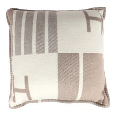 a brown and white pillow on a white background