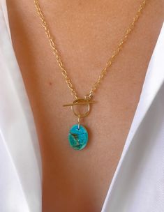 "A vibrant blue/green turquoise stone hung from the toggle clasp of a 14k gold filled cable chain. Turquoise is the birthstone of the December born though this pendant screams Summer! The necklace measures 18\" in the chain with another 1.5\" for the pendant drop, though custom lengths are available on request. It is available in gold filled, rose gold filled and sterling silver. All pieces come beautifully gift wrapped. Turquoise, the captivating sea-green stone of the ancients, represents wisdom, tranquility, protection, good fortune, and hope. Ancient peoples believed in its profound power to protect, as well as its tranquil energy and its association with enduring love. Gold filled is made by heat and pressure bonding a layer of karat gold to a metal core. Unlike gold plated, gold fill Turquoise Necklace With Adjustable Metal Chain, Gold Turquoise Adjustable Pendant Necklace, Gold-tone Metal Chain Necklace With Toggle Clasp, December Born, One-of-a-kind Bohemian Gold Turquoise Necklace, Turquoise Gold-plated Necklace With Adjustable Chain, Blue Green Turquoise, Vibrant Blue, Green Turquoise