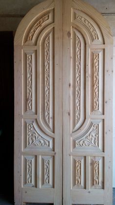 two wooden doors with intricate carvings on the front and back sides, both made out of wood