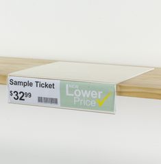 a new lower price ticket sitting on top of a shelf