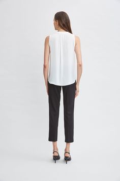 Luxurious Georgette elevates this minimalist top. Its split neckline and soft shoulder pleat detail add a touch of feminine flair. This essential piece will take you from Spring into Fall. T-Tahari Sleeveless Split Neck Georgette Shirt Relaxed Fit; Runs true to size. Model is 5'9" and wearing size S Imported Style #: THF41048 Georgette Shirt, Minimalist Top, Black Friday Specials, White Star, Pair Of Pants, Global Fashion, Neck Shirt, Fashion Brand, Button Down Shirt