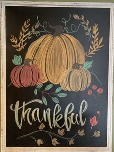 a chalkboard with some pumpkins on it and the words thank you written in cursive writing