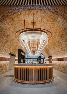 the inside of a building with a circular light fixture hanging from it's ceiling