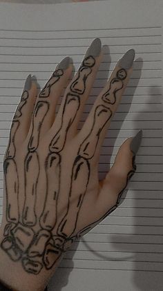 a hand with lines drawn on it next to a notebook