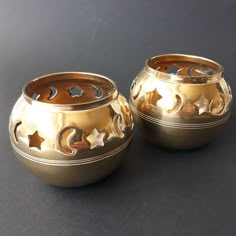 two gold vases sitting on top of a table