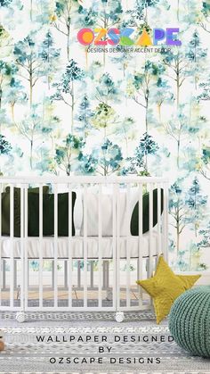 a baby crib in front of a wallpaper design with blue and green trees