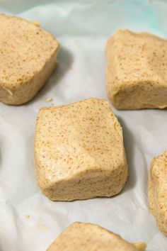 several pieces of food sitting on top of wax paper