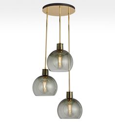 three lights hanging from a ceiling fixture with glass globes on the top and bottom