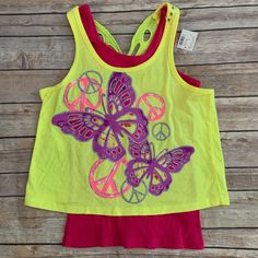 Yellow And Pink Tank Top With A Glittery Graphic Design On The Front And Cut Out Sequined Butterfly Design On The Back. Size 12. Nwt Multicolor Spring Playwear Tops, Cute Yellow Sleeveless Top, Playful Tank Top For Spring Playtime, Yellow Tops For Spring Playwear, Yellow Spring Tops For Playwear, Multicolor Spring T-shirt For Play, Fun Yellow Sleeveless Top, Yellow Playful Tops For Playtime, Playful Yellow Tops For Playtime