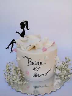 a wedding cake with bride and groom silhouettes on it