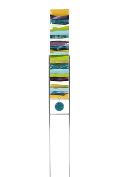 a tall metal stand with an abstract painting on it's sides and a blue disc in the middle