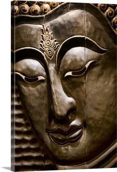 a large metal buddha head on display in a room