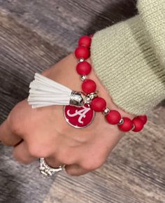 Adorable College Team Bracelets w/Tassel. Adjustable clasp. **Spend $50 or more & get FREE SHIPPING! **Spend $50 or more & have the option at check out to use Sezzle or Klarna for convenient payments. Casual Adjustable Tassel Jewelry, Team Bracelets, College Team, University Of Alabama, Auburn, Alabama, Tassels, University, Free Shipping