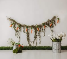 carrots and flowers are hanging on the wall