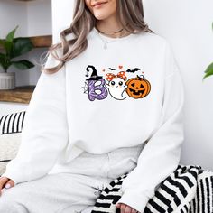 Halloween Ghost Sweatshirt, Boo Shirt, Spooky Ghost Hoodie, Spooky Season Ghost Sweater, Spooky Vibes Shirt, Halloween Gifts ORDERING: 1. Review all photos 2. Choose Size and Color from drop-down menu 3. If personalization box is available, add your text color 4. Add each shirt to cart one at a time 5. Click "Add to Cart" - you can go back to add more products 6. Click "Proceed to Checkout" 7. Add note to seller for any requests BULK DISCOUNTS AND SPECIAL REQUESTS: We offer bulk discounts and are open to special requests. Please feel free to direct message us with any inquiries. CARE INSTRUCTIONS: Wash inside out, gentle cycle, cold water, tumble dry low, medium iron. PRODUCTION AND SHIPPING: Processing time is next day. First Class Shipping is 2-5 business days (after processing time). If White Long Sleeve Halloween Sweatshirt, White Long Sleeve Fun Sweatshirt, White Hooded Top For Halloween, Fun White Hoodie For Fall, White Fun Sweater For Fall, Fun White Sweater For Fall, White Halloween Hoodie Long Sleeve, White Halloween Hoodie, White Long Sleeve Halloween Hoodie