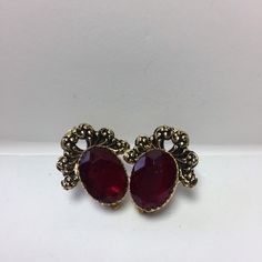 Wonderful set of vintage rhinestone ruby red color Earrings. 1970's clip on. These lucite earrings are a beautiful deep red color.Antiqued gold tone settings. Please see photos. Box may vary. Vintage Red Earrings For Party, Vintage Red Clip-on Earrings For Evening, Vintage Red Clip-on Earrings For Anniversary, Red Vintage Clip-on Earrings For Anniversary, Vintage Red Clip-on Earrings, Vintage Ruby Evening Jewelry, Red Vintage Clip-on Earrings, Formal Jeweled Clip-on Costume Jewelry Earrings, Red Jeweled Earrings For Evening