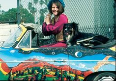 a woman sitting on top of a colorful car