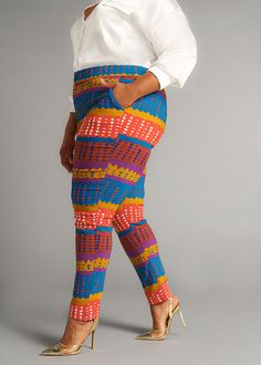 Style#4022OTA Our Talia African Print Stretch Pants are designed for the modern individual who values both flexibility and fashion. Meaning 'to bloom' in Arabic, these flattering skinny pants adapts to your lifestyle, providing the flexibility that you need without compromising on fashion. Wear with your favorite pair of boots, heels, or sneakers and pair with our Uyai stretch blazer. *Colors may look slightly different depending on the fabric used for construction* Item photographs brighter. Se Orange Stretch Pants For Workwear, Stretch Orange Pants For Workwear, Stretch Orange Pants With Elastic Waistband, Fitted Multicolor Bottoms For Workwear, Spring Fitted Orange Leggings, Spring Orange Fitted Leggings, Stretch Multicolor Bottoms For Workwear, Stretch Multicolor Pants For Work, Orange Stretch Straight Pants