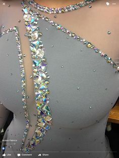 the back of a woman's dress with sequins and beads on it